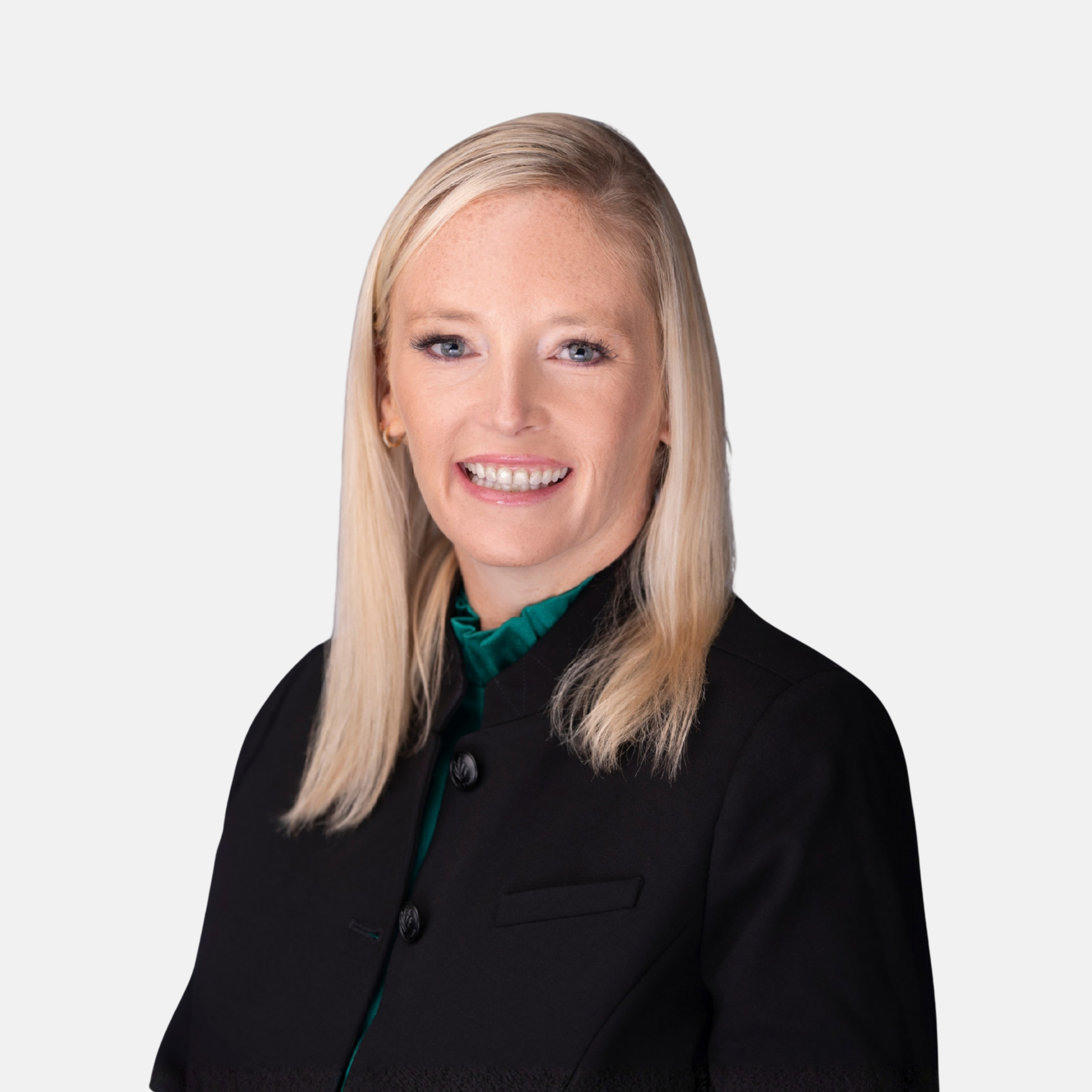 Headshot of Elizabeth A. Jewell with blonde hair and a dark blazer smiling against a light background.
