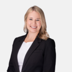 Headshot of Kelsey R. Hunt with blonde hair, wearing a dark blazer and white top, smiling against a light background